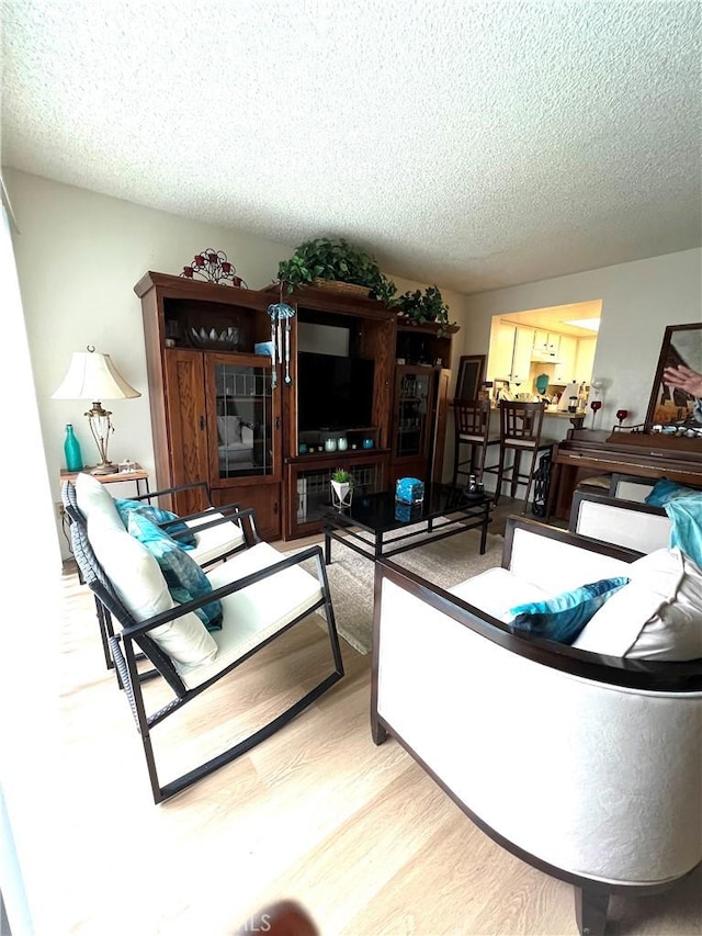 1209 W Cypress Ave Unit C, Lompoc, CA 93436 - living room with wood finished floors and a textured ceiling