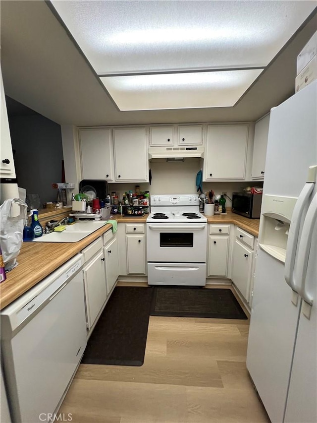 1209 W Cypress Ave Unit C, Lompoc, CA 93436 - kitchen with white appliances, under cabinet range hood, white cabinets, and light countertops