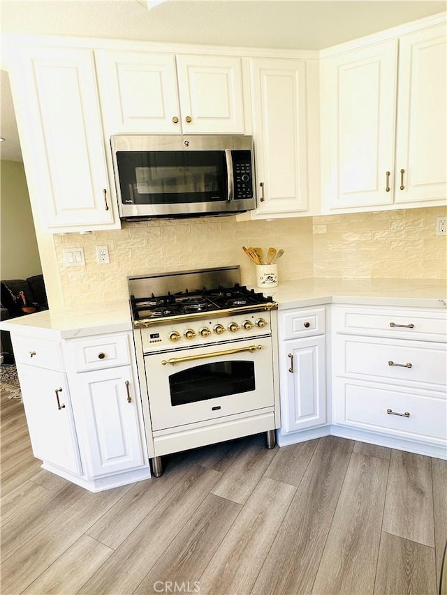 3931 Cottonwood Grove Trl, Calabasas, CA 91301 - kitchen featuring stainless steel microwave, white range with gas cooktop, light wood finished floors, and light countertops