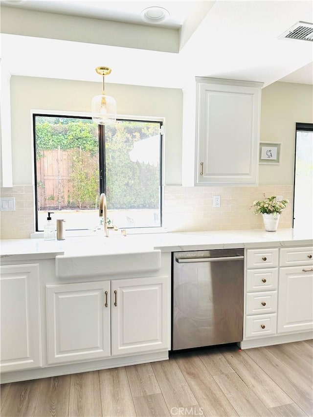 3931 Cottonwood Grove Trl, Calabasas, CA 91301 - kitchen featuring stainless steel dishwasher, light countertops, white cabinets, backsplash, and light wood-style flooring