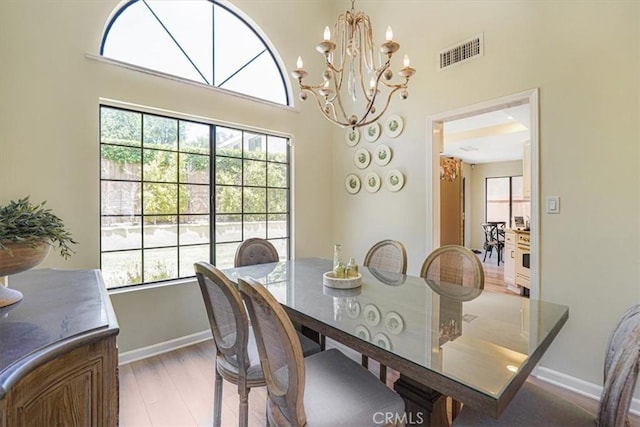 3931 Cottonwood Grove Trl, Calabasas, CA 91301 - dining room with a chandelier, light wood-style floors, and a towering ceiling