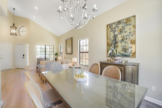 3931 Cottonwood Grove Trl, Calabasas, CA 91301 - dining area with a chandelier, plenty of natural light, wood finished floors, and high vaulted ceiling