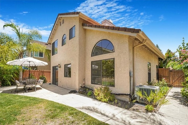 3931 Cottonwood Grove Trl, Calabasas, CA 91301 - rear view of property featuring stucco siding, a patio area, and a gate
