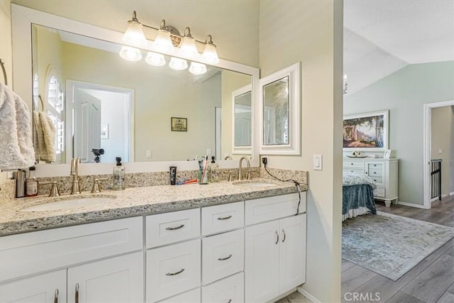 3931 Cottonwood Grove Trl, Calabasas, CA 91301 - ensuite bathroom featuring double vanity, wood finished floors, and lofted ceiling