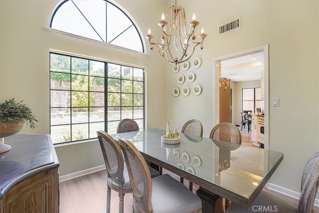 3931 Cottonwood Grove Trl, Calabasas, CA 91301 - dining area with a chandelier, light wood finished floors, and a high ceiling