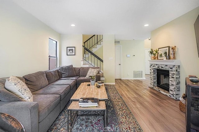 3931 Cottonwood Grove Trl, Calabasas, CA 91301 - living area featuring wood finished floors, stairway, recessed lighting, and a fireplace