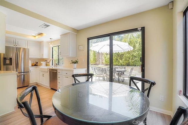 3931 Cottonwood Grove Trl, Calabasas, CA 91301 - dining space featuring light wood-style flooring and a tray ceiling