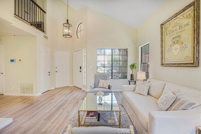 3931 Cottonwood Grove Trl, Calabasas, CA 91301 - living room featuring wood finished floors, high vaulted ceiling, and a chandelier