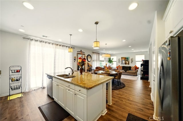 5073 S Mccleve Way W, Ontario, CA 91762 - kitchen featuring appliances with stainless steel finishes, white cabinets, recessed lighting, a kitchen island with sink, and open floor plan