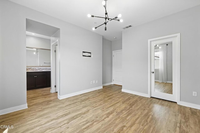623 W Foothill Blvd Unit 43, Glendora, CA 91741 - unfurnished bedroom with a chandelier, light wood finished floors, and ensuite bath