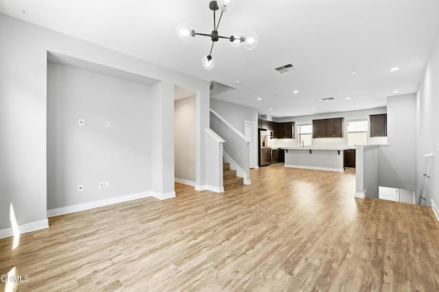623 W Foothill Blvd Unit 43, Glendora, CA 91741 - unfurnished living room featuring light wood-type flooring, stairway, recessed lighting, and a chandelier