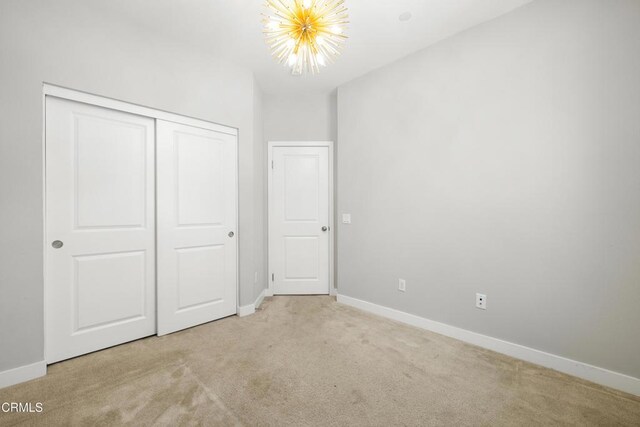 623 W Foothill Blvd Unit 43, Glendora, CA 91741 - unfurnished bedroom featuring light carpet, a chandelier, and a closet