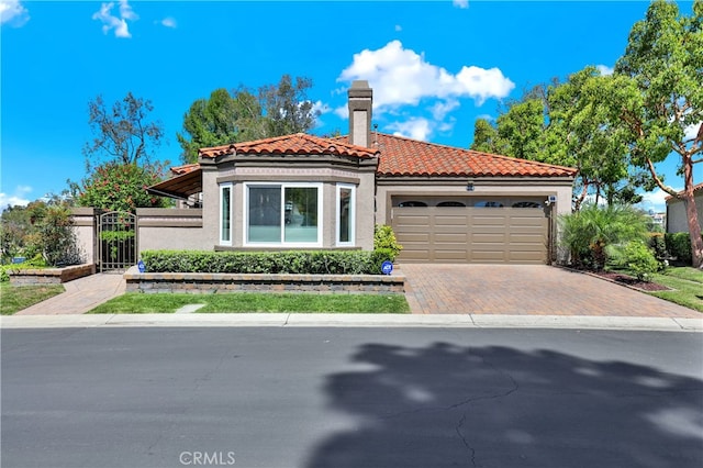 28241 Alava, Mission Viejo, CA 92692 - mediterranean / spanish-style home featuring stucco siding, a tiled roof, an attached garage, decorative driveway, and a chimney