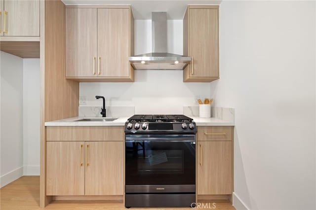 8840 Valjean Ave, North Hills, CA 91343 - kitchen with stainless steel gas range, wall chimney exhaust hood, light brown cabinets, and light countertops