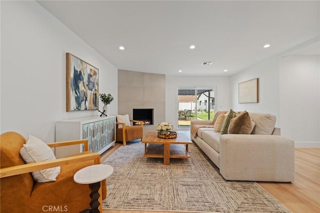 8840 Valjean Ave, North Hills, CA 91343 - living area with light wood-style flooring, recessed lighting, and a large fireplace