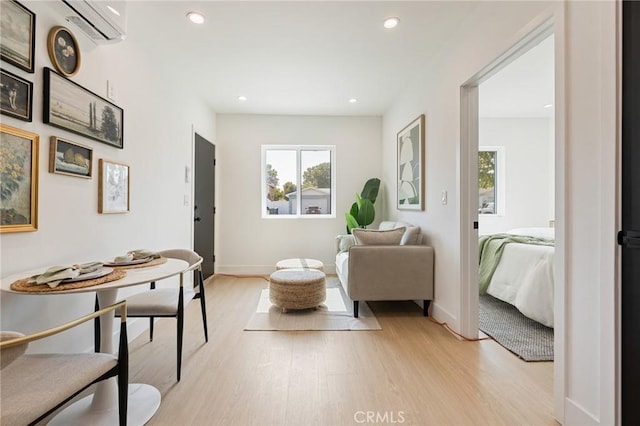 8840 Valjean Ave, North Hills, CA 91343 - living area with light wood finished floors, plenty of natural light, a wall mounted air conditioner, and recessed lighting