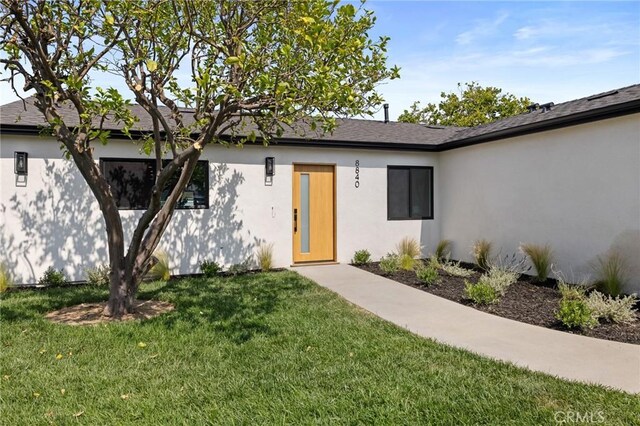8840 Valjean Ave, North Hills, CA 91343 - property entrance featuring a yard and stucco siding