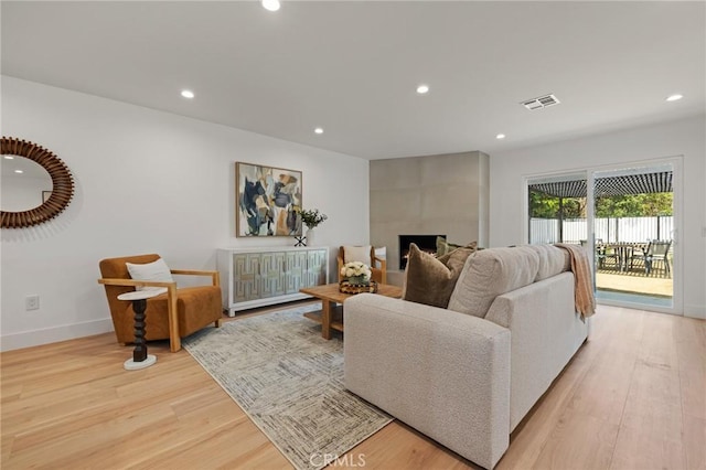 8840 Valjean Ave, North Hills, CA 91343 - living area with recessed lighting, light wood finished floors, and a tile fireplace