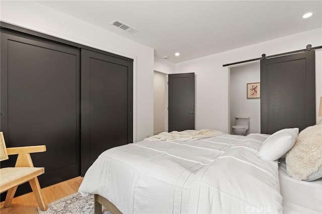 8840 Valjean Ave, North Hills, CA 91343 - bedroom featuring light wood-type flooring, a barn door, recessed lighting, and a closet