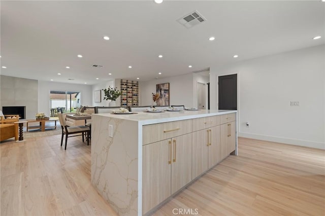 8840 Valjean Ave, North Hills, CA 91343 - kitchen featuring open floor plan, modern cabinets, light wood-style flooring, recessed lighting, and a spacious island