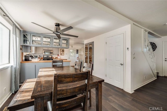 25389 Oak Glen Rd, Twin Peaks, CA 92391 - dining space featuring dark wood-type flooring, ceiling fan, and stairway