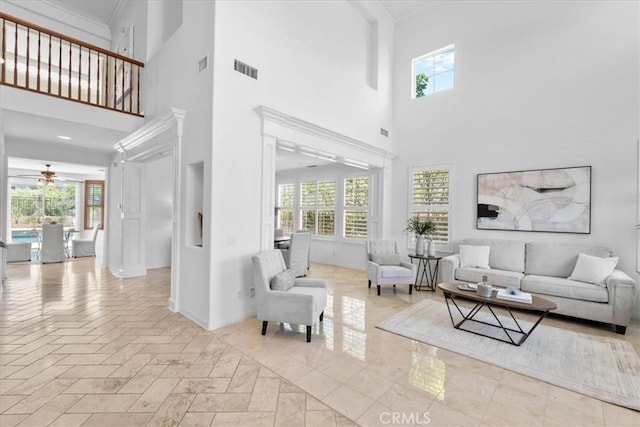 20342 Via Cellini, Porter Ranch, CA 91326 - living area with a towering ceiling, ceiling fan, plenty of natural light, and ornamental molding