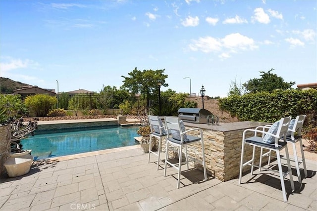 20342 Via Cellini, Porter Ranch, CA 91326 - view of swimming pool featuring an outdoor kitchen, a fenced backyard, and a patio