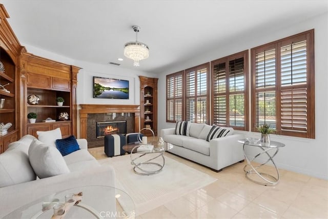 20342 Via Cellini, Porter Ranch, CA 91326 - living room with a fireplace, built in shelves, and a chandelier