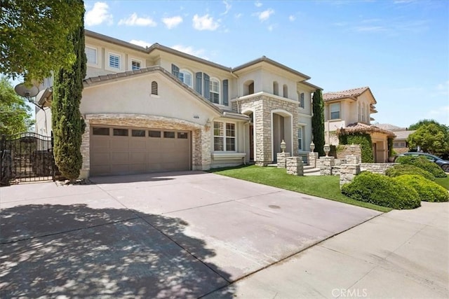20342 Via Cellini, Porter Ranch, CA 91326 - mediterranean / spanish home with stucco siding, driveway, stone siding, and an attached garage