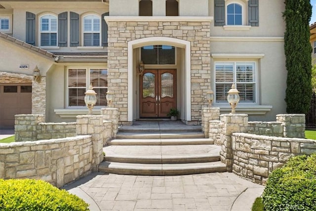 20342 Via Cellini, Porter Ranch, CA 91326 - property entrance with french doors, stone siding, and stucco siding