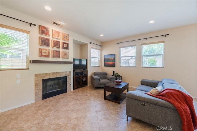 5681 Mapleview Dr, Jurupa Valley, CA 92509 - living area with plenty of natural light, a fireplace, and recessed lighting