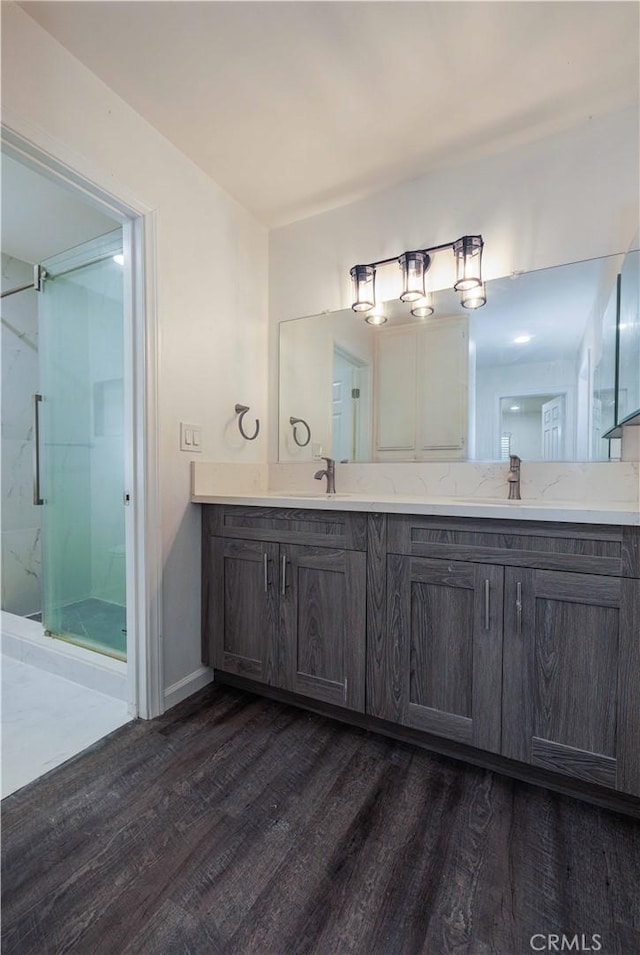 1806 N Fairview St Unit J, Santa Ana, CA 92706 - bathroom featuring wood finished floors, double vanity, and a marble finish shower