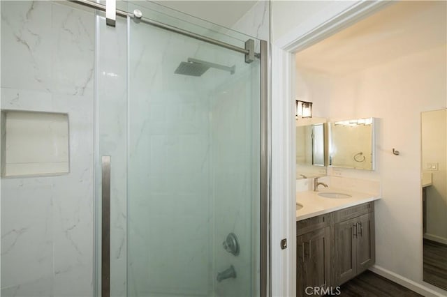 1806 N Fairview St Unit J, Santa Ana, CA 92706 - bathroom with a marble finish shower, double vanity, and wood finished floors