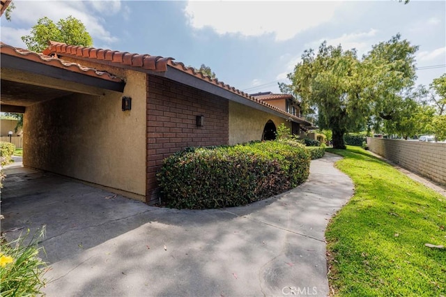 1806 N Fairview St Unit J, Santa Ana, CA 92706 - view of side of home with stucco siding and a tiled roof