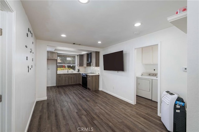 1806 N Fairview St Unit J, Santa Ana, CA 92706 - kitchen with black electric range oven, washer and clothes dryer, dark wood-type flooring, recessed lighting, and light countertops