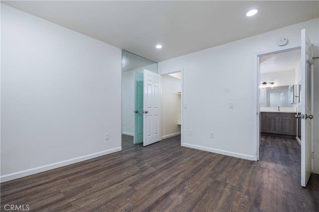 1806 N Fairview St Unit J, Santa Ana, CA 92706 - unfurnished bedroom with dark wood-style flooring and recessed lighting