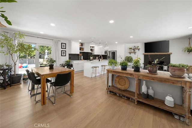 450 Pecan St, Arroyo Grande, CA 93420 - dining area featuring light wood-type flooring, recessed lighting, and a fireplace