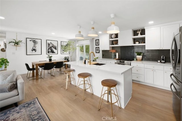450 Pecan St, Arroyo Grande, CA 93420 - kitchen with appliances with stainless steel finishes, open shelves, recessed lighting, a breakfast bar, and decorative backsplash