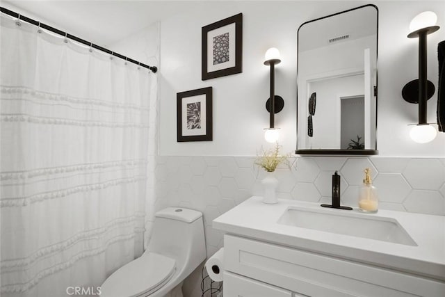 450 Pecan St, Arroyo Grande, CA 93420 - bathroom featuring tile walls, vanity, a wainscoted wall, and curtained shower