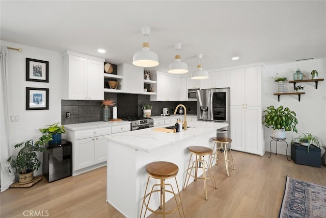 450 Pecan St, Arroyo Grande, CA 93420 - kitchen with open shelves, stainless steel appliances, decorative backsplash, white cabinetry, and recessed lighting