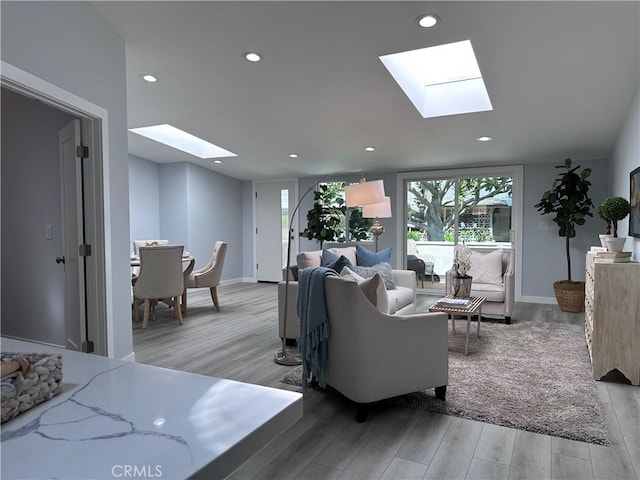 13361 El Dorado Unit 201K, Seal Beach, CA 90740 - living area featuring a skylight, light wood-type flooring, and recessed lighting