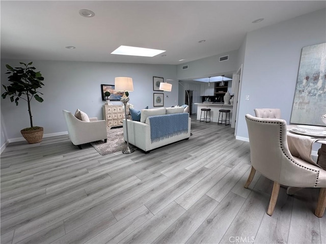 13361 El Dorado Unit 201K, Seal Beach, CA 90740 - living area with a skylight, light wood-style floors, and recessed lighting