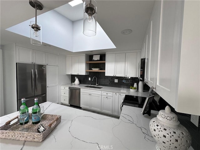 13361 El Dorado Unit 201K, Seal Beach, CA 90740 - kitchen featuring appliances with stainless steel finishes, open shelves, decorative backsplash, light stone countertops, and decorative light fixtures