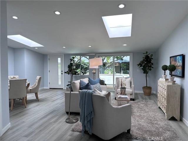 13361 El Dorado Unit 201K, Seal Beach, CA 90740 - living area with a skylight, light wood-type flooring, and recessed lighting