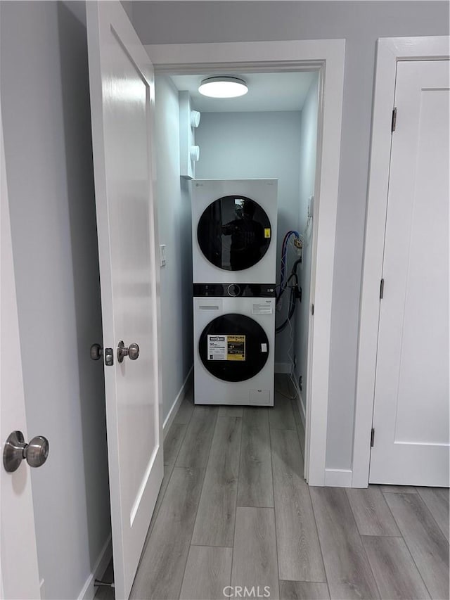 13361 El Dorado Unit 201K, Seal Beach, CA 90740 - washroom with stacked washer / dryer and wood finished floors