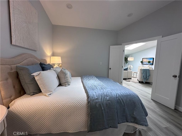 13361 El Dorado Unit 201K, Seal Beach, CA 90740 - bedroom featuring light wood-type flooring and lofted ceiling