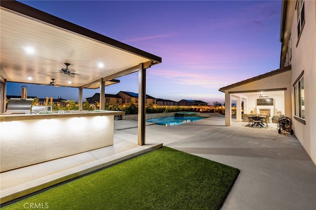 16671 Zest Ct, Riverside, CA 92503 - view of patio with ceiling fan, a bar, a pool with connected hot tub, and area for grilling