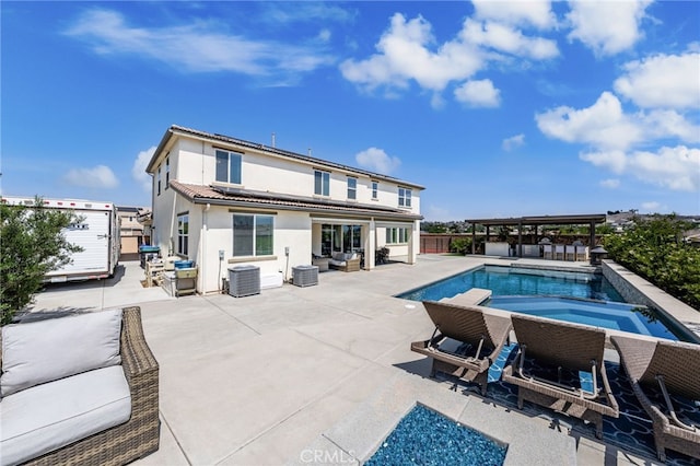 16671 Zest Ct, Riverside, CA 92503 - back of house featuring stucco siding, a patio area, roof mounted solar panels, and an outdoor living space
