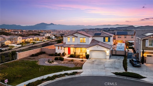 16671 Zest Ct, Riverside, CA 92503 - traditional home featuring a residential view, concrete driveway, stucco siding, solar panels, and a mountain view