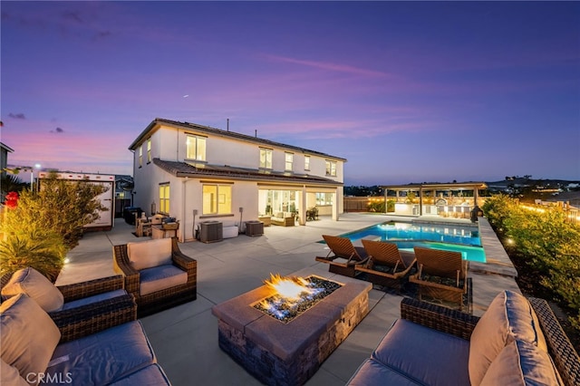 16671 Zest Ct, Riverside, CA 92503 - rear view of property with an outdoor living space with a fire pit, a patio, stucco siding, and an outdoor pool